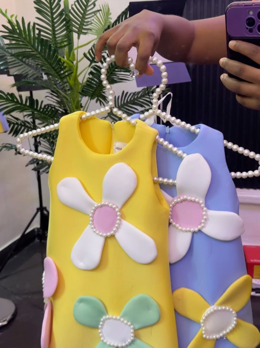 Yellow and lilac daisy dresses on pearl hangers